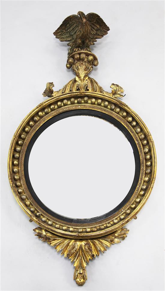 A large Regency circular gilt convex wall mirror, 4ft 10in. x 2ft 7.5in.